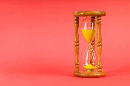Time concept - hourglass against the gradient background