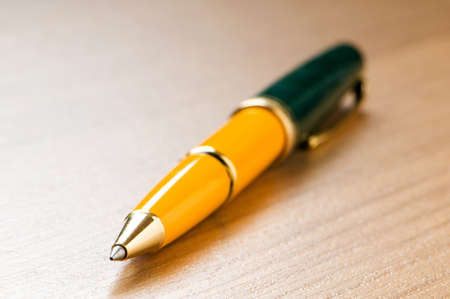 Writing silver pen on the wooden backgroundの写真素材