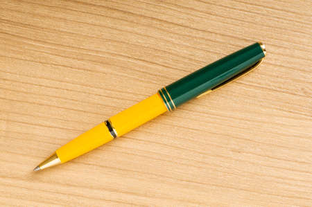 Writing silver pen on the wooden backgroundの写真素材