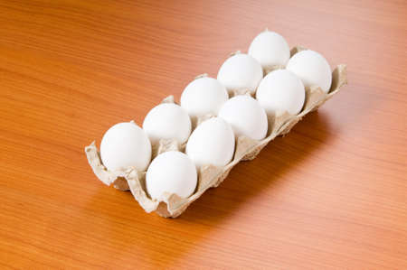 Many white eggs on the wooden table