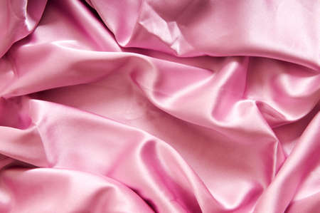 Bright satin fabric folded to be used as backgroundの写真素材