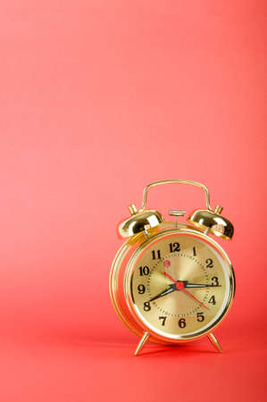Time concept - alarm clock against colorful background
