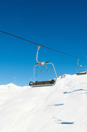 Ski lift chairs on bright winter dayの写真素材