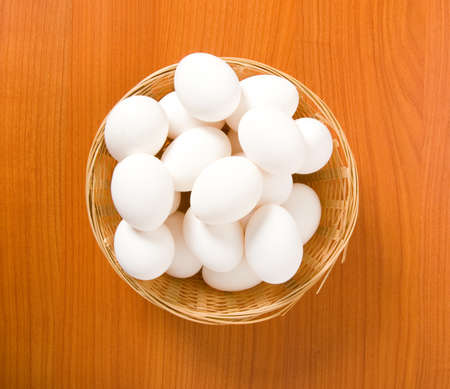 Many white eggs on the wooden tableの写真素材