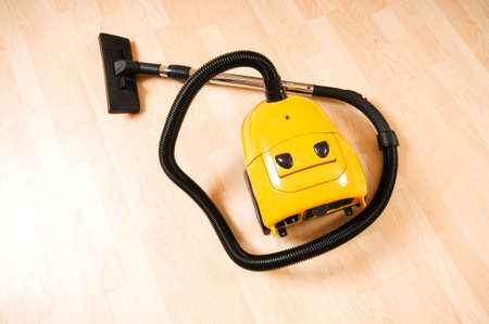 Vacuum cleaner on the polished wooden floor の写真素材