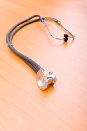 Medical concept - stethoscope on the wooden tableの写真素材