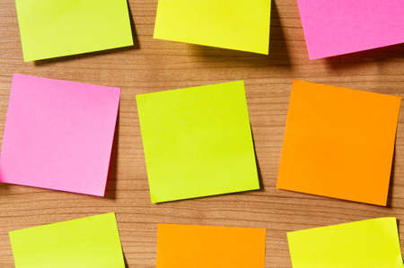 Many reminder notes on the wooden background