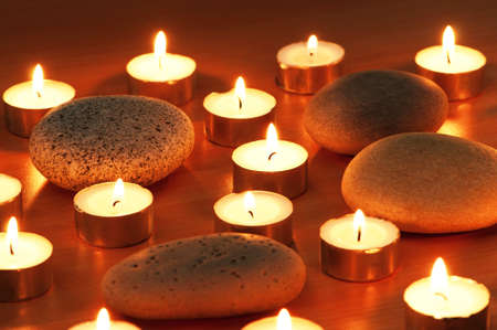 Burning candles and pebbles for aromatherapy sessionの写真素材