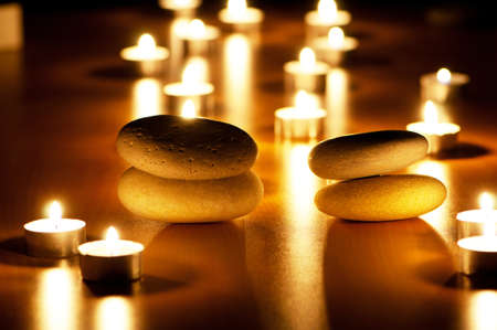 Burning candles and pebbles for aromatherapy sessionの写真素材