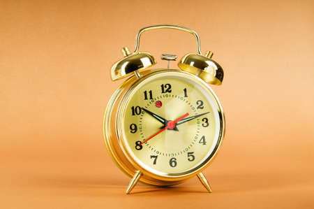 Time concept - alarm clock against colorful backgroundの写真素材