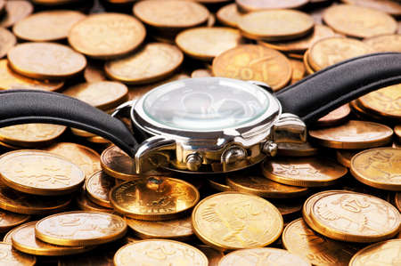 Time is money concept with watch and coins	の写真素材