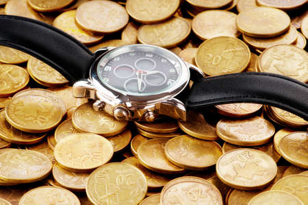 Time is money concept with watch and coins	の写真素材