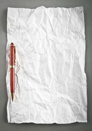 Wrinkled paper background with penの写真素材