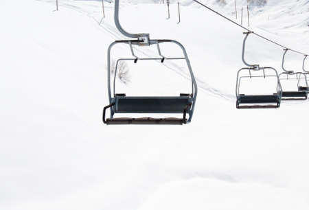 Ski lift chairs on bright winter day の写真素材