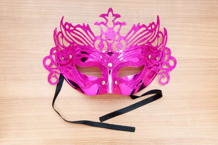 Ornate masks isolated on the wooden backgroundの写真素材