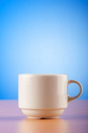 White cup against colourful gradient on the tableの写真素材
