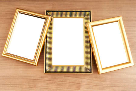 Picture frames on the polished wooden background