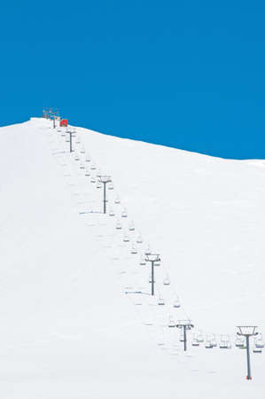 Ski lift chairs on bright winter day の写真素材