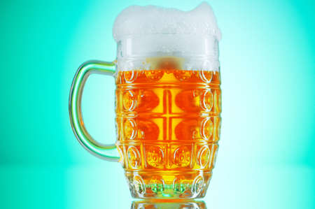 Beer glasses against the colorful gradient backgroundの写真素材