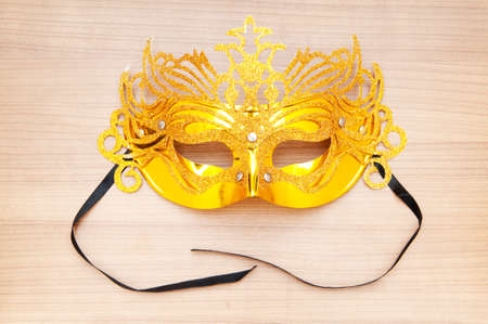 Ornate masks isolated on the wooden backgroundの写真素材