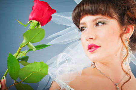 Beautiful bride with rose in studio shootingの写真素材