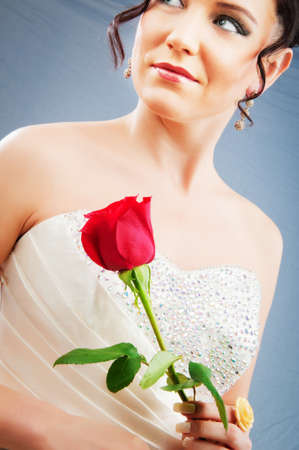 Beautiful bride with rose in studio shootingの写真素材