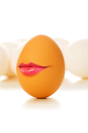 Funny concept - Brown egg on white with lipsの写真素材