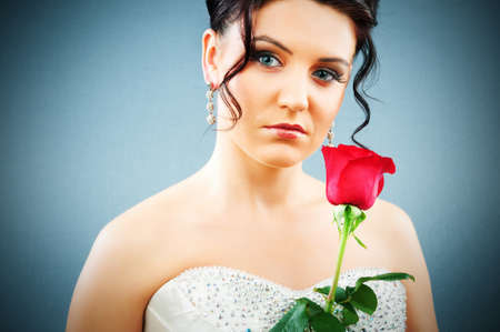 Beautiful bride with rose in studio shootingの写真素材