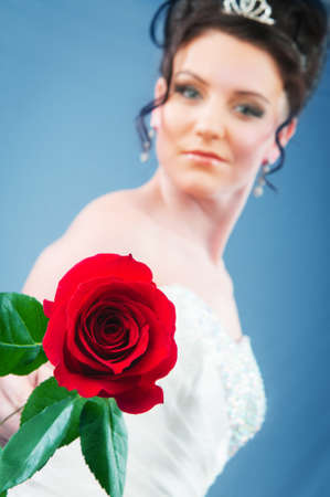 Beautiful bride with rose in studio shootingの写真素材