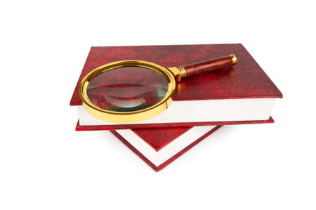 Magnifying glass over the stack of books の写真素材