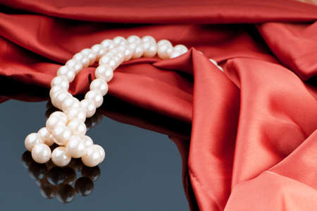 Pearls necklace on satin backgroundの写真素材