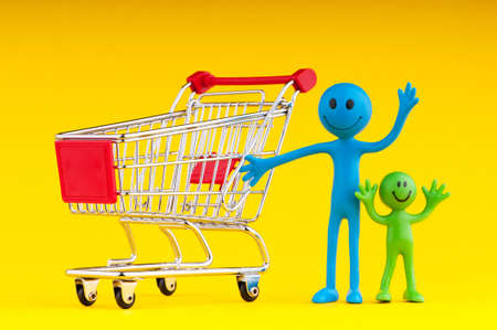 Happy family with shopping cartの写真素材