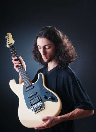 Guitar player against the dark background