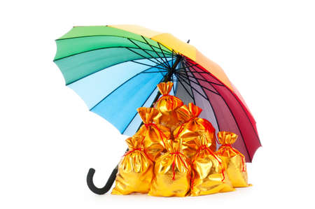 Golden sacks under protection of umbrellaの写真素材