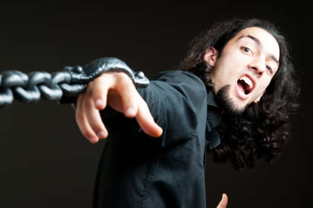 Man with metal chain around himの写真素材