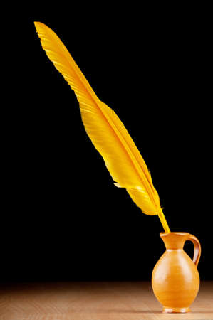 Writing feather against gradient backgroundの写真素材