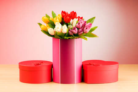 Giftbox and tulips against gradient background