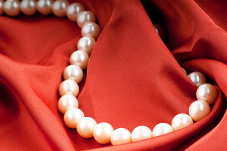 Pearls necklace on satin backgroundの写真素材