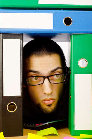 Businessman with many folders on white