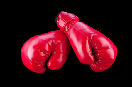 Red boxing gloves isolated on black