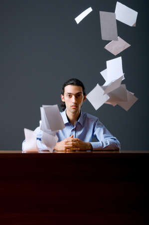 Flying paper and businessman in office