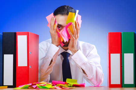 Businessman with many office folders の写真素材