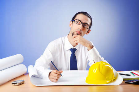 Young engineer looking at drawingsの写真素材