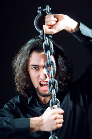 Man chained in the dark roomの写真素材