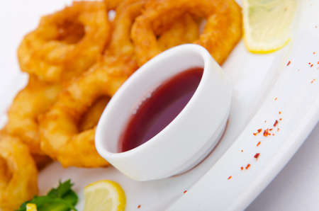 Fried calamari rings served with sauceの写真素材