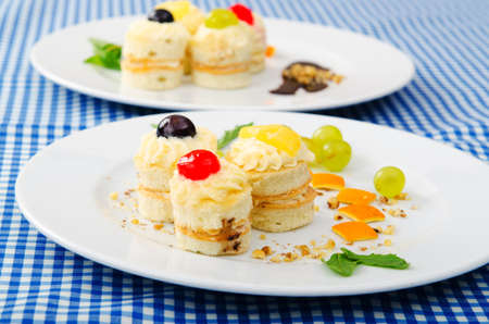 Plate full of tasty mini cakes