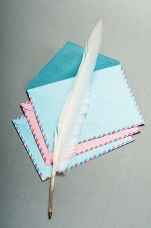 Letter and feather on the background