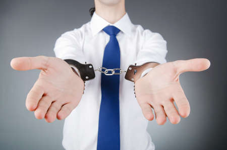 Businessman handcuffed for his crimesの写真素材