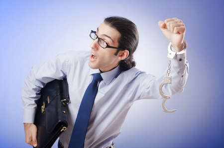 Businessman handcuffed for his crimesの写真素材