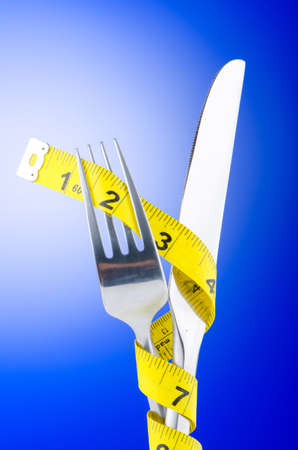Dieting concept with fork and meterの写真素材
